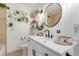 Bright bathroom featuring floating shelves, matte black hardware, a round mirror and decorative accents at 3929 Shoshone St, Denver, CO 80211