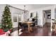 Festive dining room featuring a wooden table, modern lighting, and a decorated Christmas tree at 3929 Shoshone St, Denver, CO 80211