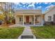 Charming front porch featuring stately columns and a welcoming swing and bench at 3929 Shoshone St, Denver, CO 80211