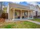 Cozy front porch with seating and classic columns, perfect for relaxing outdoors at 3929 Shoshone St, Denver, CO 80211