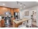 Well-equipped kitchen with granite countertops, stainless steel appliances, and a central island at 3929 Shoshone St, Denver, CO 80211