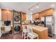 Efficient kitchen design with integrated washer/dryer, wood cabinets, and a granite island at 3929 Shoshone St, Denver, CO 80211