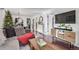 Stylish living room with dark wood floors, a cozy gray couch, and modern furnishings at 3929 Shoshone St, Denver, CO 80211