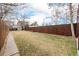 Spacious backyard with a well-maintained lawn, a tall fence for privacy, and ample space for gardening or recreation at 3929 Shoshone St, Denver, CO 80211