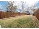 Expansive backyard featuring a tall wooden fence, well-kept lawn, and ample space for various activities at 3929 Shoshone St, Denver, CO 80211