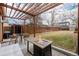 Inviting backyard patio with pergola, fire pit, dining area, and well-maintained lawn, perfect for outdoor enjoyment at 3929 Shoshone St, Denver, CO 80211