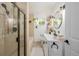 Bathroom featuring modern vanity, sleek fixtures, and glass-enclosed shower at 3929 Shoshone St, Denver, CO 80211