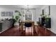 Bright dining area featuring wood floors, table, and modern chandelier at 3929 Shoshone St, Denver, CO 80211