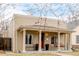 Inviting single-story home featuring a covered porch with classic columns and a porch swing at 3929 Shoshone St, Denver, CO 80211