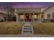 Charming single-story home featuring a covered porch with a swing, bench, and red door at 3929 Shoshone St, Denver, CO 80211