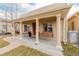 Inviting front porch with swing, complemented by elegant columns and charming details at 3929 Shoshone St, Denver, CO 80211