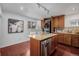 Modern kitchen with island, stainless dishwasher, and stacked washer and dryer at 3929 Shoshone St, Denver, CO 80211