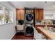 Home office nook in kitchen featuring stacked washer and dryer and desk at 3929 Shoshone St, Denver, CO 80211