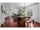 Open living space featuring dining table, a spacious living room, and dark wood floors at 3929 Shoshone St, Denver, CO 80211