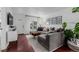 Bright living room with hardwood floors, a large gray sofa, and stylish decor at 3929 Shoshone St, Denver, CO 80211