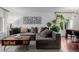 Comfortable living room with a sectional sofa, a modern coffee table, and a large houseplant at 3929 Shoshone St, Denver, CO 80211