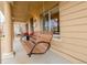 Close-up of cozy wooden porch swing on a covered front porch, creating a relaxing outdoor space at 3929 Shoshone St, Denver, CO 80211