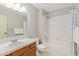 Clean bathroom with shower/tub combo and wood vanity at 1749 Foster Dr, Longmont, CO 80501