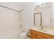 Simple bathroom with shower/tub and wood vanity at 1749 Foster Dr, Longmont, CO 80501