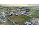 Aerial view of a residential area, showcasing the layout of homes and surrounding fields in the neighborhood at 29303 E 165Th Ave, Brighton, CO 80603