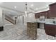 Wide angle view of basement bar with brick facade and plenty of lighting, next to basement staircase at 29303 E 165Th Ave, Brighton, CO 80603