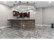 Basement bar boasts stone accents, pendant lighting, and seating, perfect for entertaining at 29303 E 165Th Ave, Brighton, CO 80603