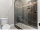 Bathroom showcasing glass enclosed shower with decorative tile accents and a modern toilet at 29303 E 165Th Ave, Brighton, CO 80603