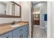 Bathroom with double sink vanity, wood look flooring, and granite countertops at 29303 E 165Th Ave, Brighton, CO 80603