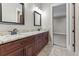 Bathroom featuring double vanity with granite countertops, elegant fixtures, and tiled floors at 29303 E 165Th Ave, Brighton, CO 80603