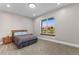 Bedroom features carpet flooring, a queen bed with two side tables, and a view to the outside at 29303 E 165Th Ave, Brighton, CO 80603