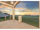 Relax on this deck offering open views, railing and a sunset sky at 29303 E 165Th Ave, Brighton, CO 80603
