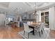 An open dining area features a wooden table, chandelier, and a view to the backyard through glass sliding doors at 29303 E 165Th Ave, Brighton, CO 80603