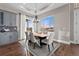A dining area features a wooden table, light fixture, and a large window with a view to the outside at 29303 E 165Th Ave, Brighton, CO 80603