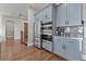 A chef's kitchen features stainless appliances and light gray custom cabinetry at 29303 E 165Th Ave, Brighton, CO 80603