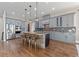 Spacious kitchen with large center island, pendant lighting, and gray cabinets at 29303 E 165Th Ave, Brighton, CO 80603