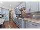 A spacious kitchen boasts light gray custom cabinets and granite countertops at 29303 E 165Th Ave, Brighton, CO 80603