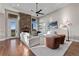 A living room features a stone fireplace, hardwood floors, large windows, and two white couches at 29303 E 165Th Ave, Brighton, CO 80603