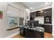 An office with a large window, desk, and built in cabinets with hardwood floors at 29303 E 165Th Ave, Brighton, CO 80603