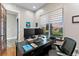An office with a large window, desk, and office chair, with art on the wall and hardwood floors at 29303 E 165Th Ave, Brighton, CO 80603