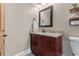 Cozy powder bath with decorative mirror, wood cabinetry, and stylish fixtures at 29303 E 165Th Ave, Brighton, CO 80603