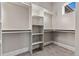 Spacious walk-in closet features built-in shelving and ample hanging space for storage solutions at 29303 E 165Th Ave, Brighton, CO 80603