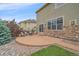 Backyard patio with seating area and stone accents on the home's exterior at 6461 S Ider St, Aurora, CO 80016