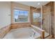 Bright bathroom featuring a tub and a glass-enclosed shower at 6461 S Ider St, Aurora, CO 80016