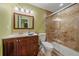 Well-lit bathroom featuring a glass shower enclosure and vanity with dark wood cabinetry at 6461 S Ider St, Aurora, CO 80016