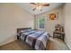 Bedroom with neutral walls, ceiling fan, and one window overlooking the backyard at 6461 S Ider St, Aurora, CO 80016