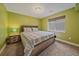 Comfortable bedroom with a window, featuring patterned bedding and a nightstand at 6461 S Ider St, Aurora, CO 80016