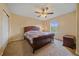 This bedroom features neutral walls, a ceiling fan, and a dark wood bed frame at 6461 S Ider St, Aurora, CO 80016