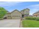Charming two-story home featuring a three-car garage and well-manicured lawn at 6461 S Ider St, Aurora, CO 80016
