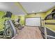 Basement workout area featuring a treadmill, elliptical, and large movie screen at 6461 S Ider St, Aurora, CO 80016