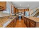 The kitchen features brown cabinets, stainless steel appliances, and granite countertops at 6461 S Ider St, Aurora, CO 80016